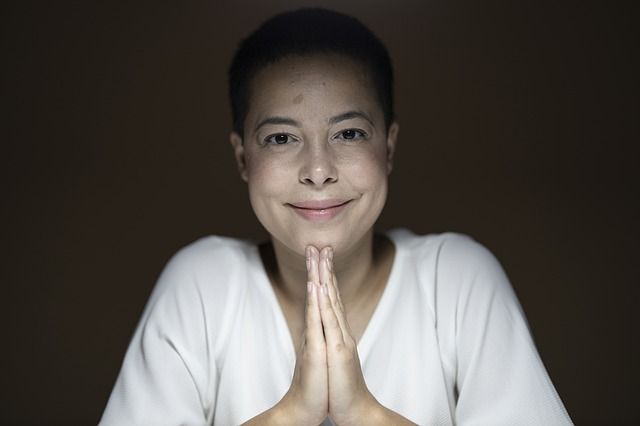 woman-smiling-with-joined-hands-in-prayer_small.jpg