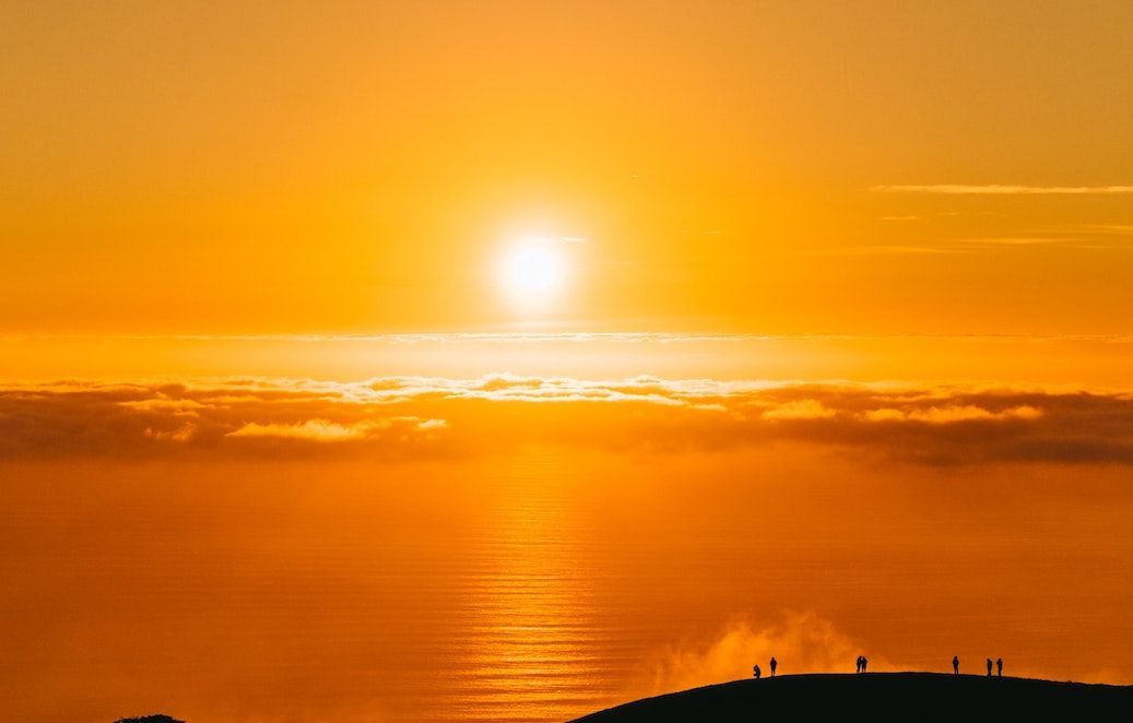 beautiful orange sunrise over round shaped mountain silhouette